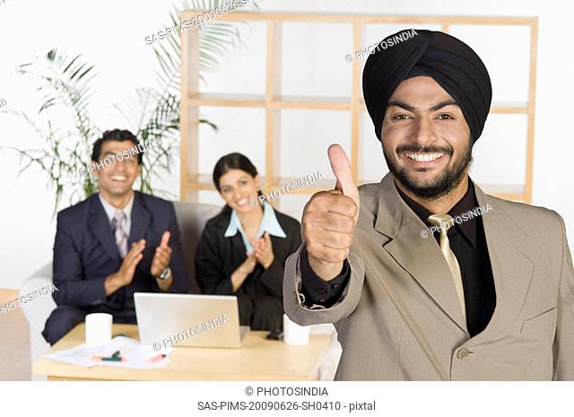 Businessman showing thumbs up sign
