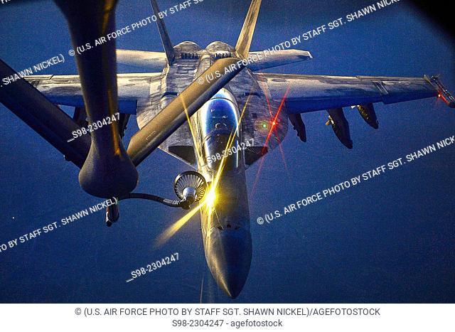 An U.S. fighter jet refuels from an Air Force KC-135 Stratotanker Aug. 21