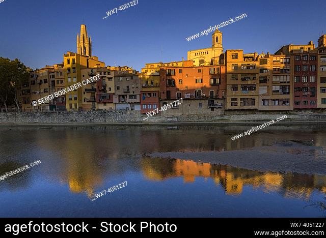 Girona Cathedral, Sant Feliu basilica and houses next to the Onyar river at sunset (Girona, Catalonia, Spain)