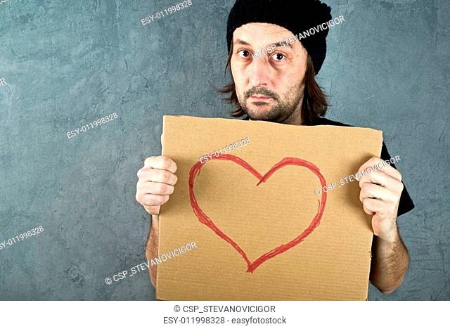 Man holding cardboard paper with heart shape drawing