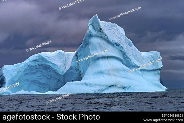 Floating Blue Iceberg Sea Water Charlotte Bay Antarctic Peninsula Antarctica. Glacier ice blue because air squeezed out of snow
