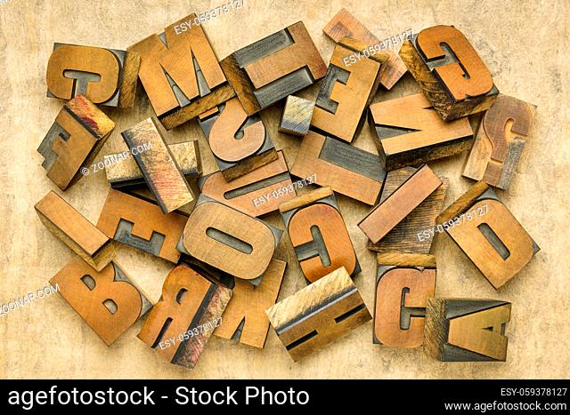 vintage letterpress wood type printing blocks, a pile of random letters on handmade bark paper