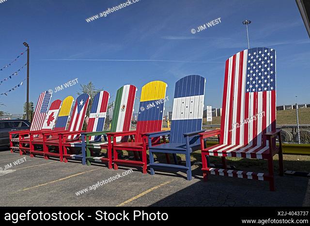 Detroit, Michigan - Large chairs painted as flags outside the Poronga Splash car wash in southwest Detroit. The flags represent the home countries of many...