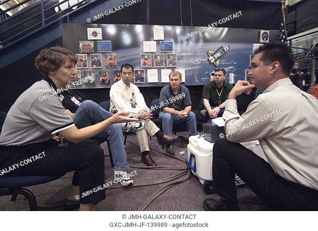The STS-114 crewmembers are briefed by United Space Alliance (USA) crew trainer Adam G. Flagan (right) during a classroom session preceding hands-on survival...
