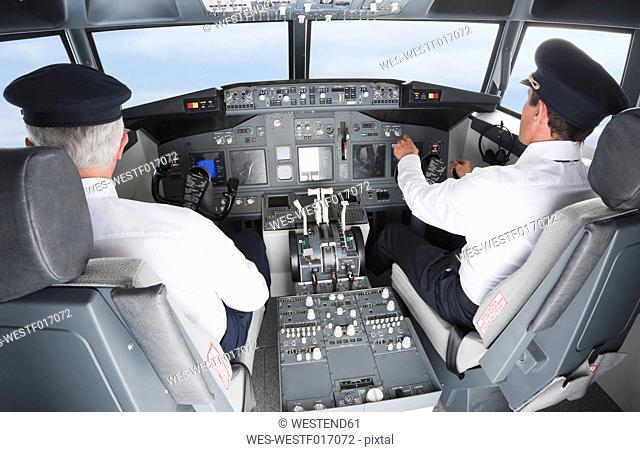 Germany, Bavaria, Munich, Pilot and co-pilot piloting aeroplane from airplane cockpit