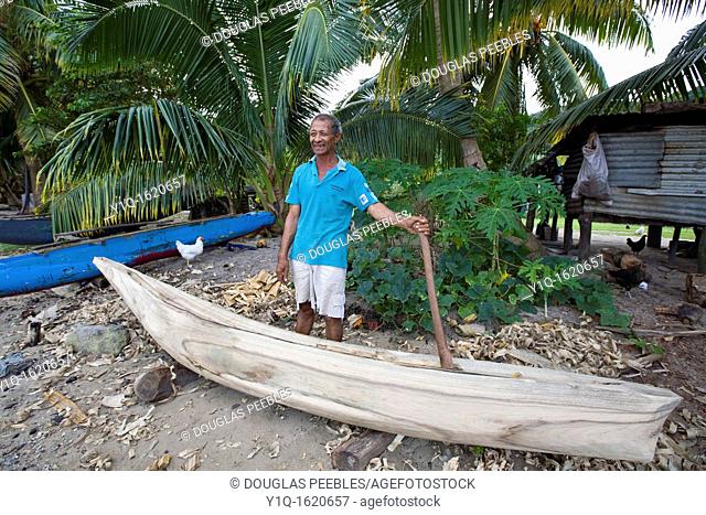 Man building outrigger canoe, Kioa Island Fiji