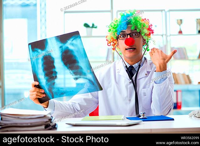 Pediatrician with x-ray image sitting in the office