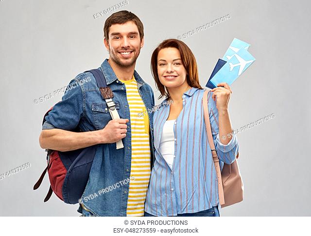 happy couple with air tickets, bags and passport