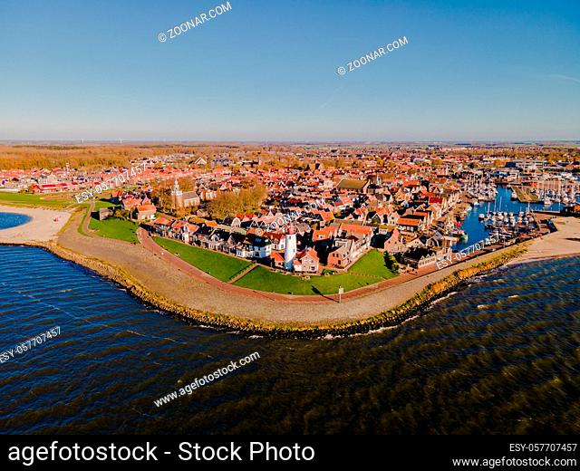 Urk lighthouse with old harbor during sunset, Urk is a small village by the lake Ijsselmeer in the Netherlands Flevoland area. beach and harbor of Urk