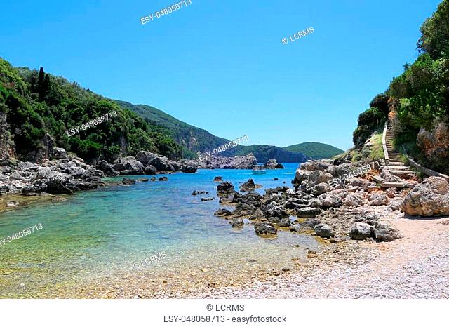 seascape of corfu island at paradise beach part Limni Glyko beach next to Liapades village. chalk rocks along the cliff