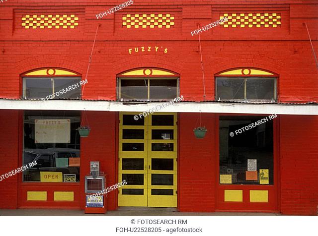 red, store front, Texas, A bright red building with yellow trim in Smithville