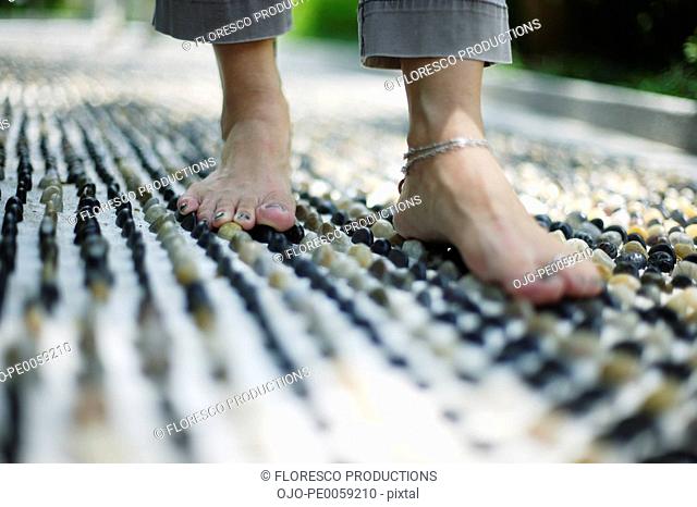 Feet on a pebble floor outdoors