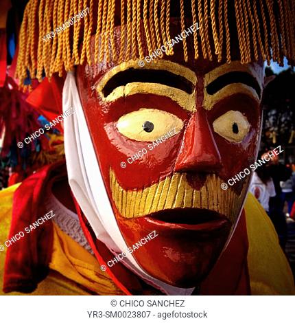 A man wearing a red mask of a men with a moustache during the anual pilgrimage to Our Lady of Guadalupe Basilica in Mexico City, Mexico