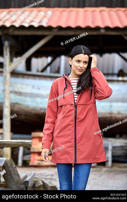 Young woman with raincoat, Pasaia, Gipuzkoa, Basque Country, Spain, Europe