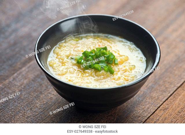 Congee bowl on wooden table background