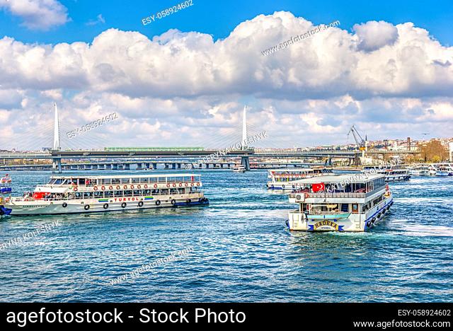 ISTANBUL, TURKEY - APRIL 04, 2019: Touristic boats near Metro bridge in Istanbul