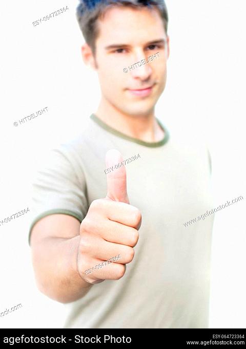 Young optimistic man showing his thumb up