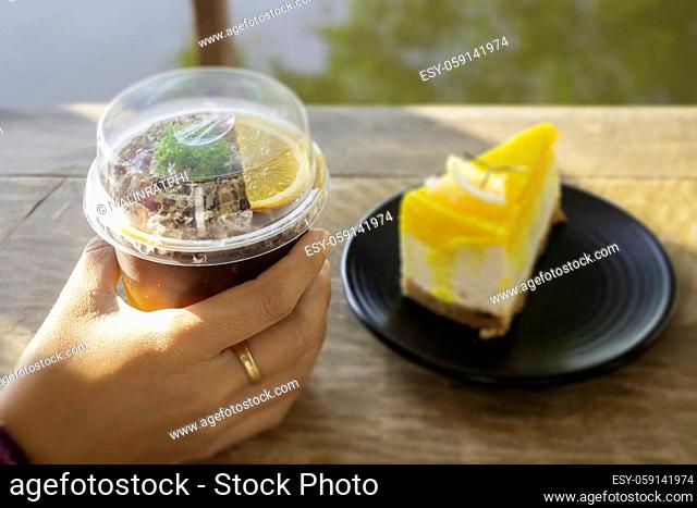 Holding a glass of iced coffee, stock photo