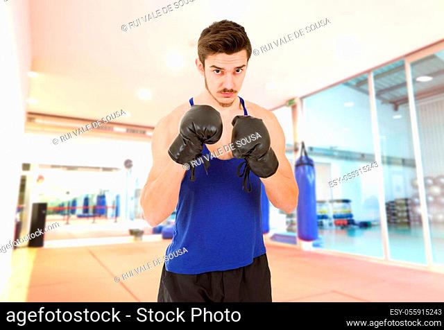 Man punching with black boxing gloves isolated on white background