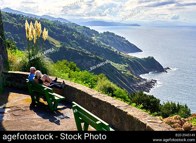 Tourist couple enjoying the Basque Coast at a viewpoint of Mount Igeldo, Donostia, San Sebastian, cosmopolitan city of 187, 000 inhabitants