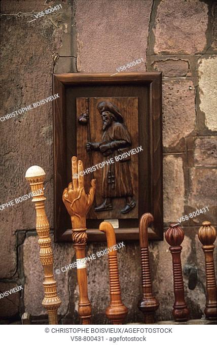 Pilgrim's staffs and woodcarving depicting St James, Saint-Jean-Pied-de-Port. French Basque Country, Pyrenees-Atlantiques, France