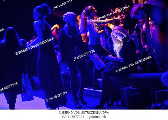 Ariane Sommer (R) sits during the fashion show of Umasan at Mercedes-Benz Fashion Week in Berlin, Germany, 17 January 2014