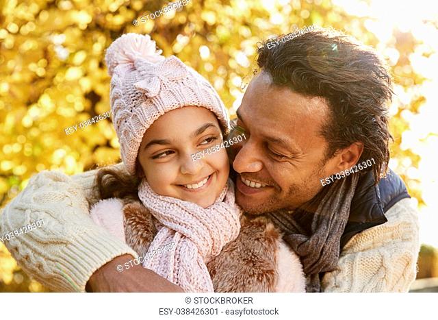 Outdoor Autumn Portrait Of Father With Daughter