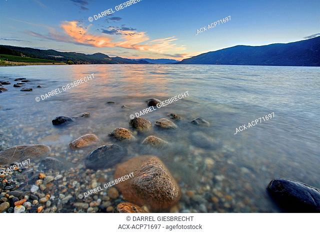 a view of Okanagan Lake at sundown with rocks in the foreground, Darrel Giesbrecht