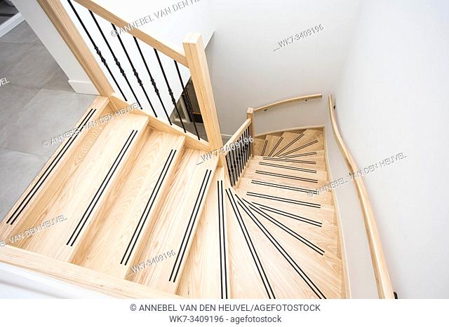 luxurious modern wooden staircase with curved landing wall modern design