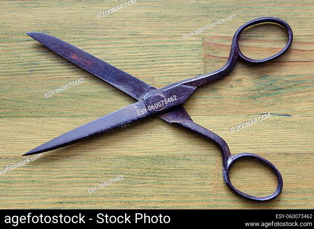 vintage scissors on the geen wooden background