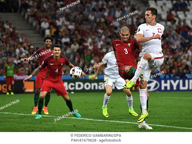 Arkadiusz Milik (R) of Poland and Pepe (2-R) of Portugal vie for the ball during the UEFA EURO 2016 quarter final soccer match between Poland and Portugal at...