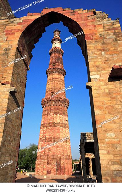 Qutab Minar through arch built in 1311 red sandstone tower , Indo-Muslim art , Delhi sultanate , Delhi, India UNESCO World Heritage Site