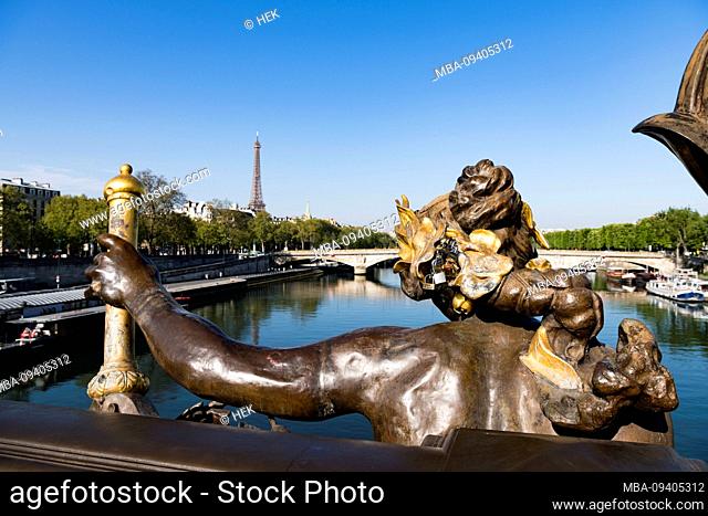 Back side of the statue La Nymph de la Seine avec les armes de la Paris by Georges Récipon on the Pont Alexandre III bridge overlooking the Eiffel Tower, Paris