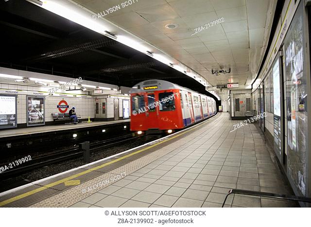 Monument Underground station platform with train pulling in, London, England, United Kingdom, Europe