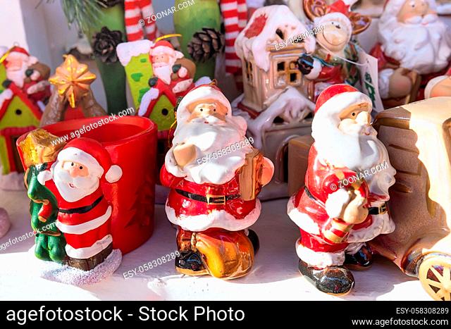 European Christmas market stall with Santa Claus figurines and different gifts