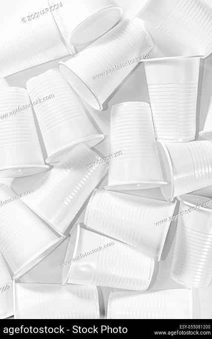 Several disposable plastic cups on a white background. Minimalistic ecologically clean still life. Green technology and ecology problem concept