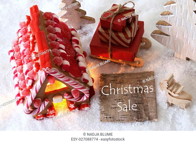 Label With English Text Christmas Sale. Gingerbread House On Snow With Christmas Decoration Like Trees And Moose. Sleigh With Christmas Gifts Or Presents
