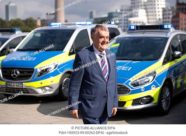23 September 2019, North Rhine-Westphalia, Duesseldorf: Herbert Reul (CDU), NRW Minister of the Interior, stands in front of new police cars Mercedes Benz Vito...