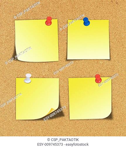 Yellow note and push pin isolated on cork board ready for your t