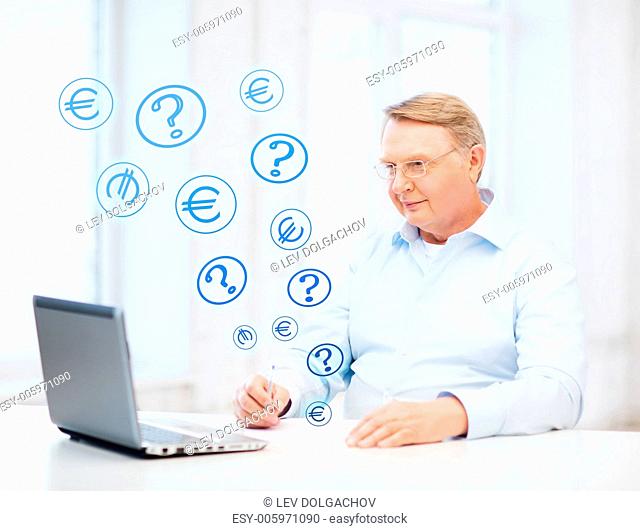 business, tax, office, school and education concept - old man in eyeglasses filling a form at home