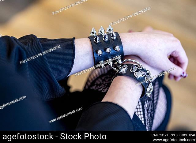 PRODUCTION - 29 November 2023, North Rhine-Westphalia, Bochum: A young participant wears bracelets with rivets and spikes
