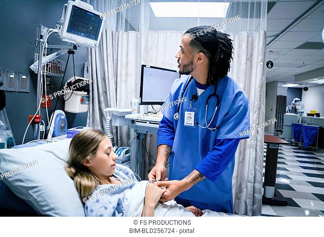 Nurse placing finger monitor on patient