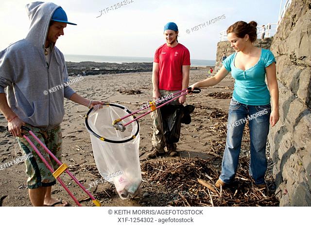 Aberystwyth University 'coast care group' student volunteers picking up litter off the beach, Wales UK