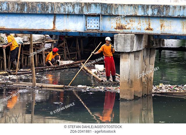 Workers on a Canal in Jakarta, Indonesia