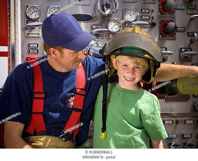 Portrait of a firefighter sitting with a boy