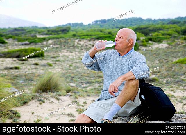 Hiker Taking a Break, Drinking a Bottle of Water