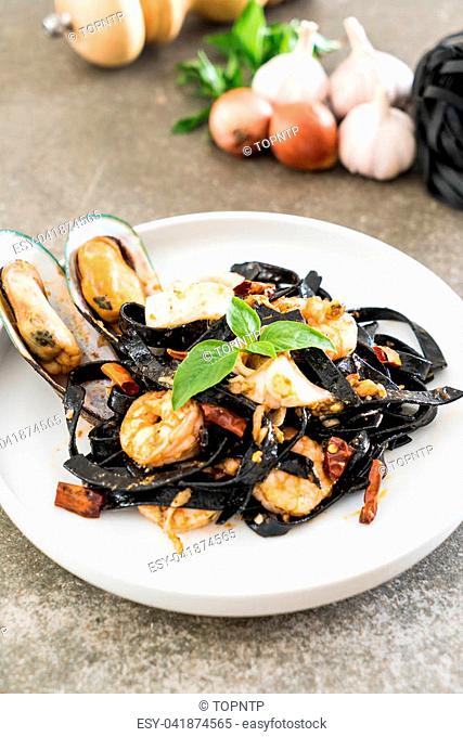 black spaghetti or pasta with seafood on plate