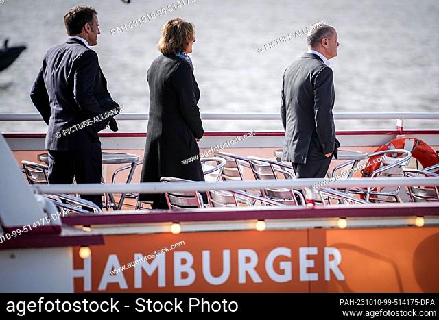 10 October 2023, Hamburg: French President Emmanuel Macron (l-r) Britta Ernst and German Chancellor Olaf Scholz (SPD) board a launch for the trip to Airbus...