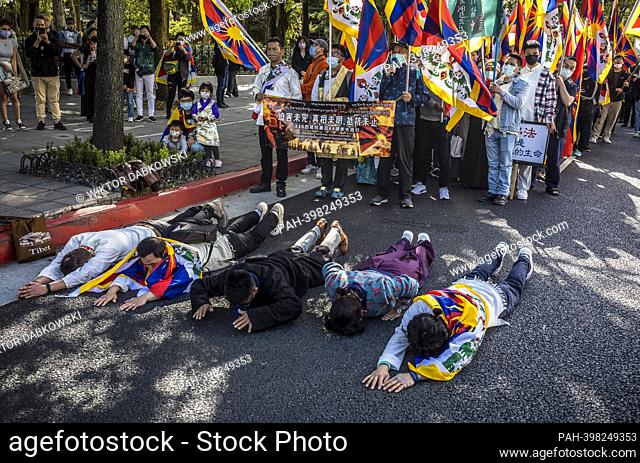 Protestors lay on the grand during prayer as Tibetans and Taiwanese who support Tibetan freedom protest on the streets of Taipei