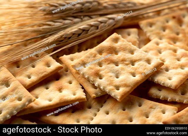 Crackers and ears of wheat placed across the screen. Close-up